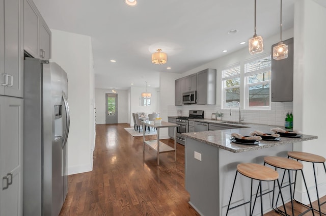 1603A 9th Ave N, Nashville, TN 37208 - kitchen with decorative backsplash, stainless steel appliances, a sink, dark wood-style floors, and gray cabinets