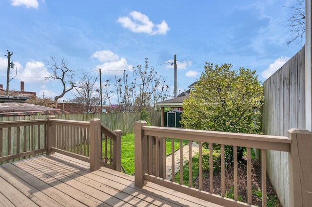 1603A 9th Ave N, Nashville, TN 37208 - wooden deck featuring a fenced backyard, a storage unit, and an outdoor structure
