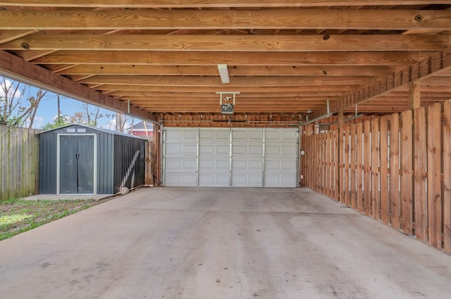 1603A 9th Ave N, Nashville, TN 37208 - garage with a garage door opener, a carport, fence, and a storage shed