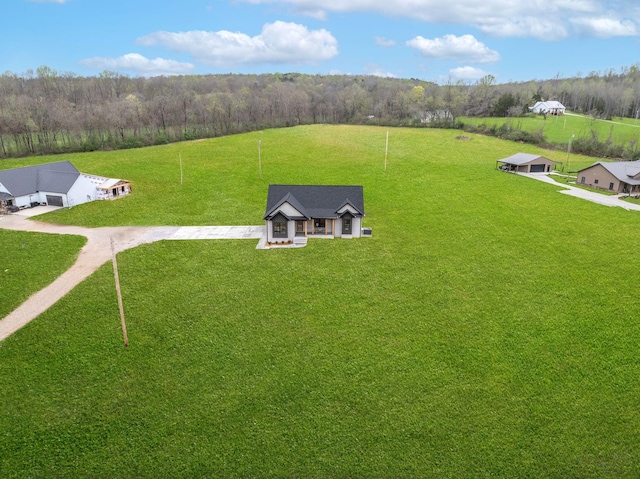 birds eye view of property featuring a wooded view