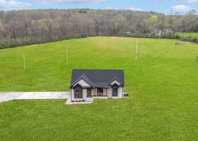 drone / aerial view with a wooded view