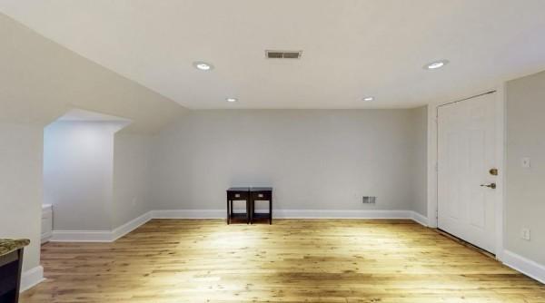 additional living space with light wood-style flooring, recessed lighting, baseboards, and vaulted ceiling