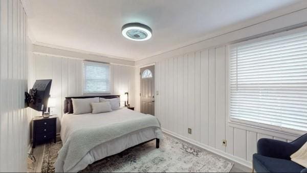 bedroom with multiple windows and baseboards