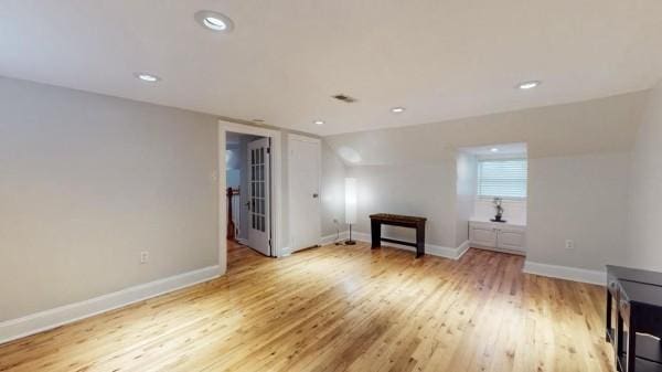 empty room featuring wood finished floors, baseboards, and recessed lighting