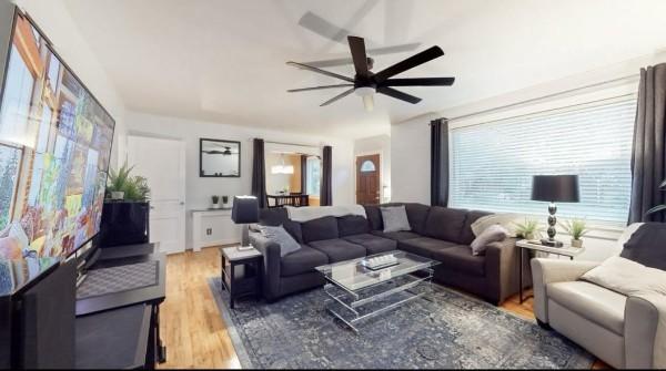 living room featuring ceiling fan and wood finished floors