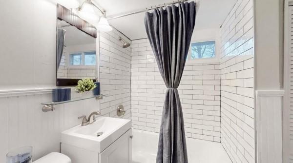 full bath featuring toilet, shower / bath combination with curtain, and vanity