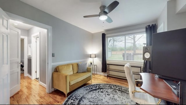 office space featuring light wood-style floors, ceiling fan, and baseboards