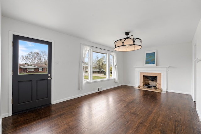 212 S Sequoia Dr, Springfield, TN 37172 - unfurnished living room featuring baseboards, visible vents, a tile fireplace, and dark wood-type flooring