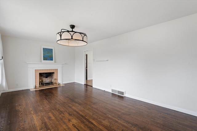 212 S Sequoia Dr, Springfield, TN 37172 - unfurnished living room featuring dark wood-type flooring, baseboards, a fireplace, and visible vents