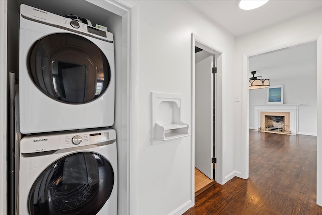 212 S Sequoia Dr, Springfield, TN 37172 - laundry area with stacked washer / dryer, baseboards, a fireplace, laundry area, and dark wood-type flooring
