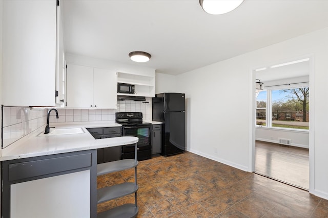 212 S Sequoia Dr, Springfield, TN 37172 - kitchen with decorative backsplash, light countertops, white cabinets, a sink, and black appliances