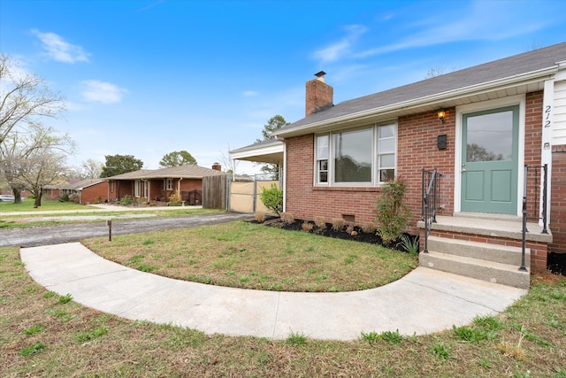 212 S Sequoia Dr, Springfield, TN 37172 - view of front facade with a front yard, a gate, brick siding, a carport, and a chimney
