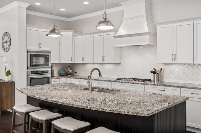 1701 Glen Echo Rd, Nashville, TN 37215 - kitchen with a sink, appliances with stainless steel finishes, premium range hood, a center island with sink, and ornamental molding