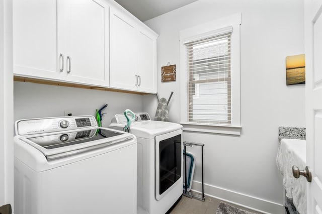 1701 Glen Echo Rd, Nashville, TN 37215 - clothes washing area featuring baseboards, cabinet space, washing machine and dryer, and tile patterned flooring