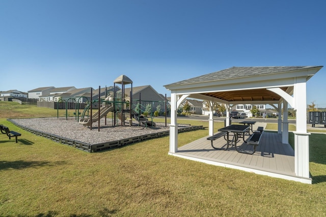 community playground with a lawn, a gazebo, and a residential view