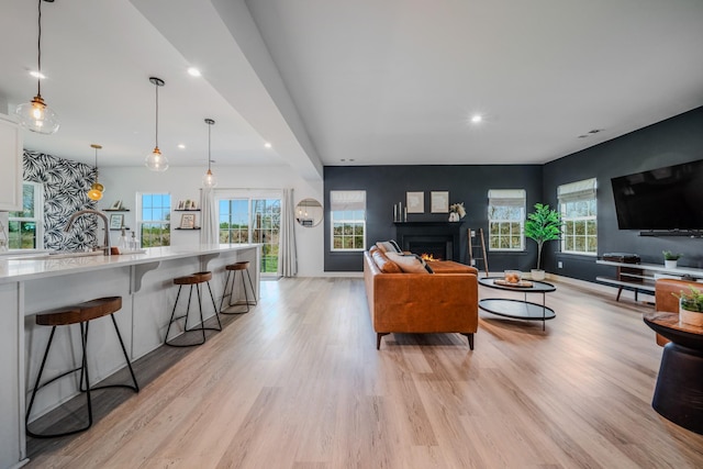 17 Kilkham Ct, Mount Juliet, TN 37122 - living room with a warm lit fireplace, light wood-style flooring, recessed lighting, and a healthy amount of sunlight