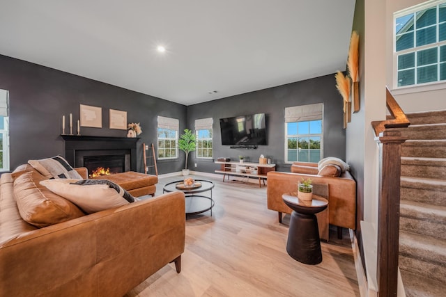 17 Kilkham Ct, Mount Juliet, TN 37122 - living room featuring a glass covered fireplace, plenty of natural light, stairway, and wood finished floors
