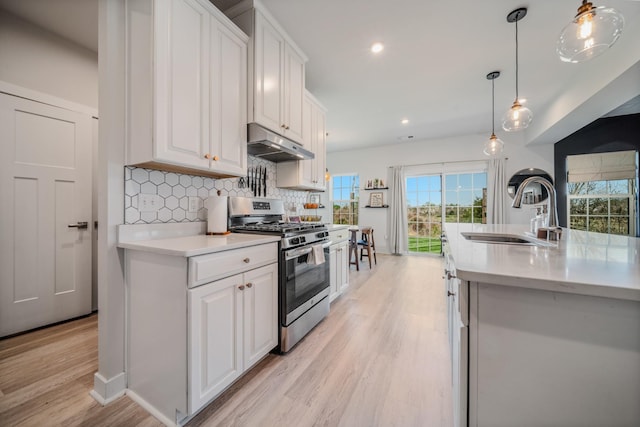 17 Kilkham Ct, Mount Juliet, TN 37122 - kitchen featuring light wood-style flooring, under cabinet range hood, stainless steel gas range, a sink, and light countertops