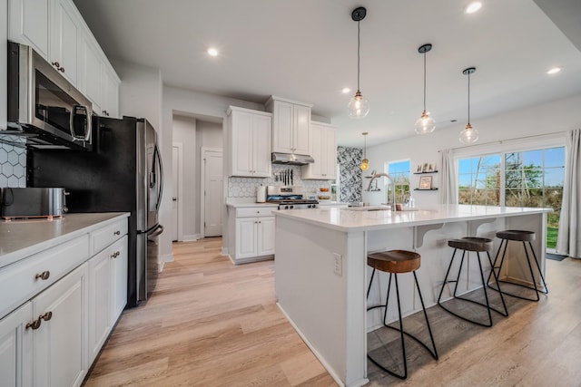 17 Kilkham Ct, Mount Juliet, TN 37122 - kitchen with tasteful backsplash, a sink, appliances with stainless steel finishes, under cabinet range hood, and white cabinetry