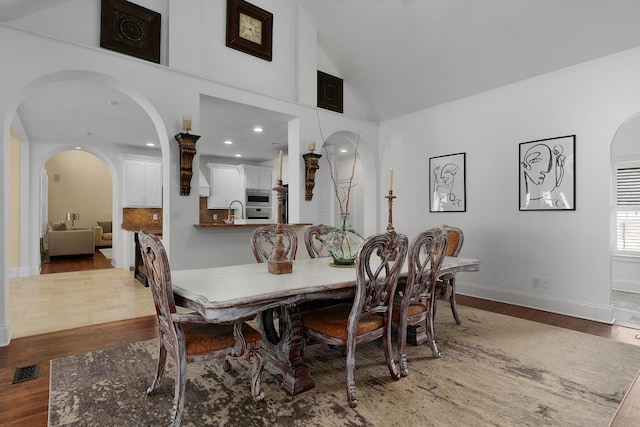 9812 Windrose Cir, Chattanooga, TN 37421 - dining room featuring arched walkways, visible vents, wood finished floors, and baseboards