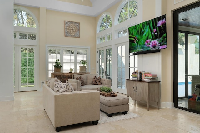 9812 Windrose Cir, Chattanooga, TN 37421 - living area with plenty of natural light, baseboards, a towering ceiling, and stone tile flooring