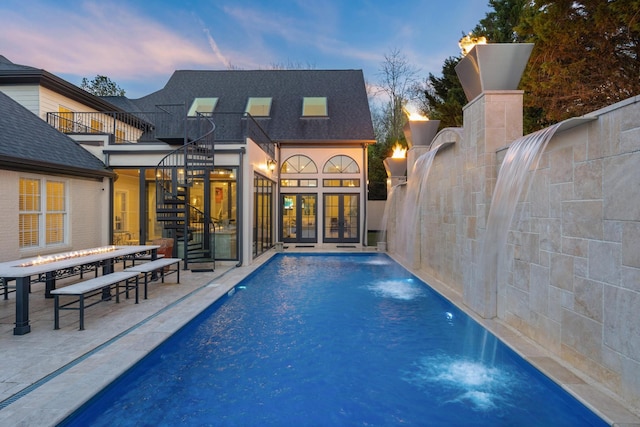 9812 Windrose Cir, Chattanooga, TN 37421 - pool at dusk featuring french doors, an outdoor pool, stairway, and a patio