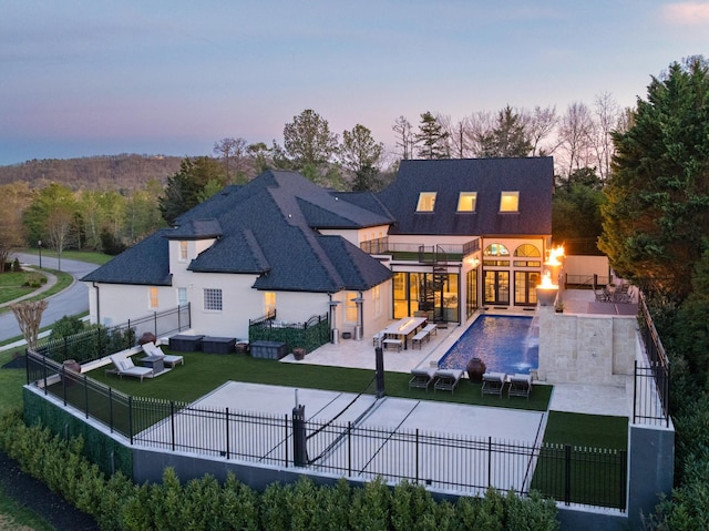 9812 Windrose Cir, Chattanooga, TN 37421 - rear view of property with a fenced in pool, a fenced backyard, stucco siding, a lawn, and a patio area
