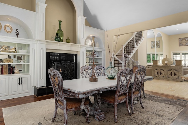 9812 Windrose Cir, Chattanooga, TN 37421 - dining area with high vaulted ceiling, a high end fireplace, stairs, wood finished floors, and built in features