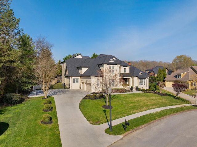 9812 Windrose Cir, Chattanooga, TN 37421 - french provincial home with a front yard, stucco siding, concrete driveway, and a garage