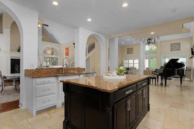 9812 Windrose Cir, Chattanooga, TN 37421 - kitchen featuring recessed lighting, stone tile flooring, a sink, light stone counters, and open floor plan
