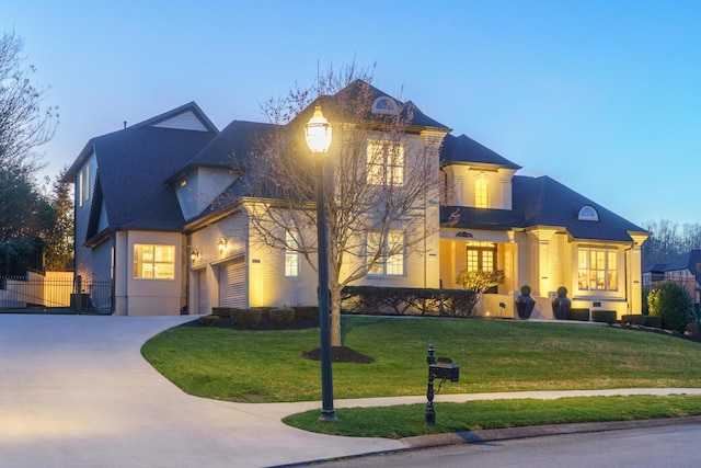 9812 Windrose Cir, Chattanooga, TN 37421 - view of front of home featuring a front yard, a balcony, concrete driveway, and a shingled roof