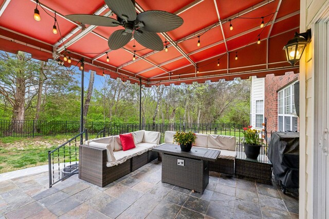 view of patio / terrace with an outdoor living space, ceiling fan, a fenced backyard, and grilling area