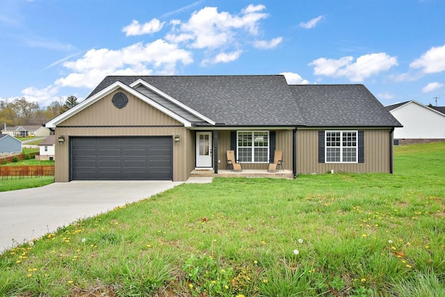 view of front facade with driveway, a front yard, an attached garage, and roof with shingles