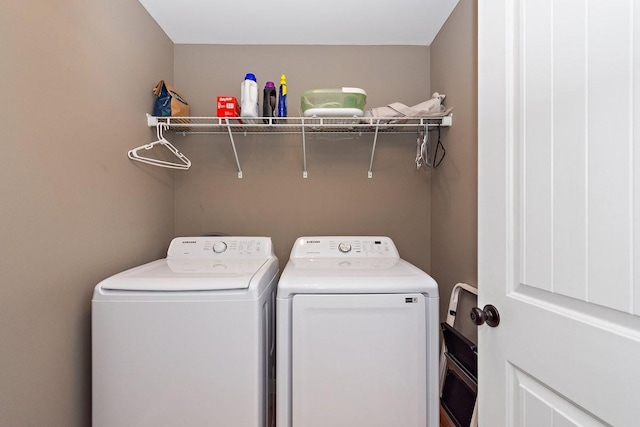 laundry area with washing machine and clothes dryer and laundry area