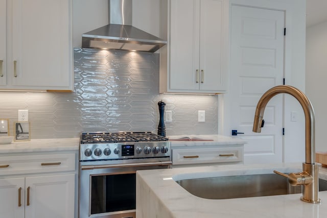 808A 45th Ave N, Nashville, TN 37209 - kitchen featuring backsplash, a sink, wall chimney exhaust hood, light stone countertops, and stainless steel range with gas cooktop