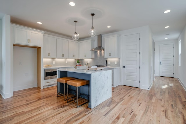 808A 45th Ave N, Nashville, TN 37209 - kitchen featuring stainless steel microwave, light countertops, wall chimney range hood, and white cabinets