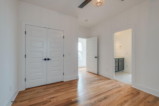 808A 45th Ave N, Nashville, TN 37209 - unfurnished bedroom with baseboards, connected bathroom, light wood-style floors, ceiling fan, and a closet
