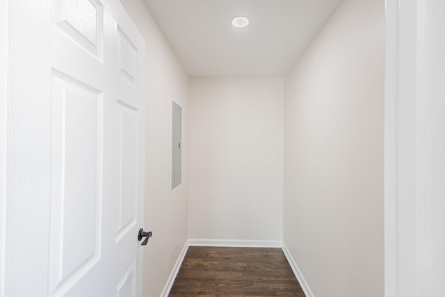 hallway with electric panel, recessed lighting, dark wood-type flooring, and baseboards