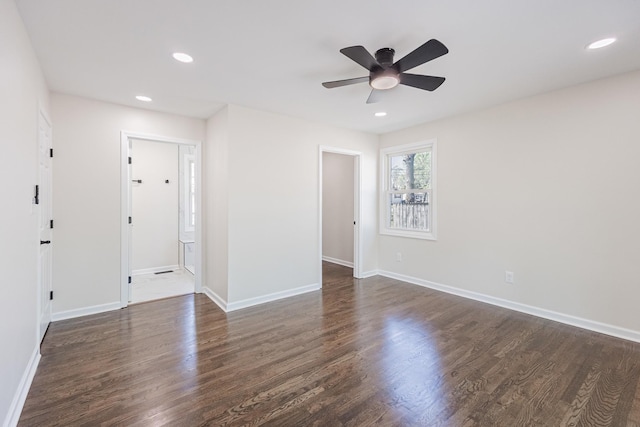 empty room featuring dark wood-style flooring, baseboards, a ceiling fan, and recessed lighting