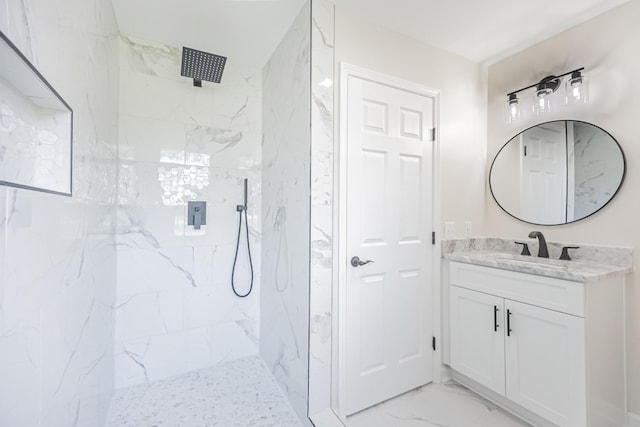 full bath with marble finish floor, vanity, and a marble finish shower