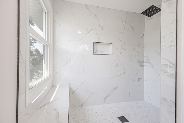 bathroom with a marble finish shower