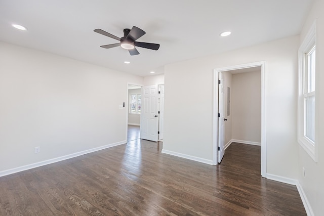 empty room with dark wood-style flooring, baseboards, a ceiling fan, and recessed lighting