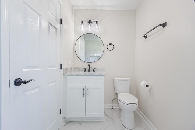 bathroom featuring vanity, marble finish floor, baseboards, and toilet