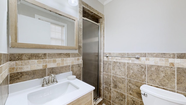 bathroom with a shower stall, tile walls, a sink, and toilet