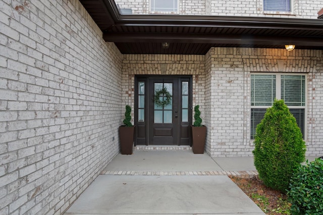 doorway to property with brick siding