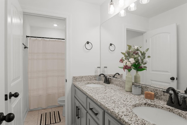 full bathroom with a shower with curtain, double vanity, toilet, and a sink