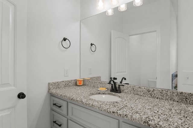 bathroom featuring toilet and vanity