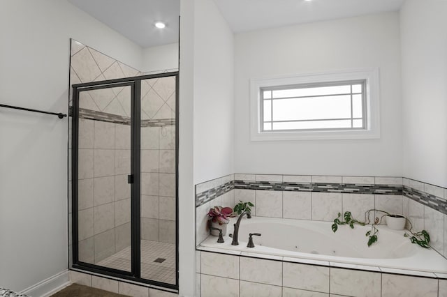 full bathroom with a stall shower and a jetted tub