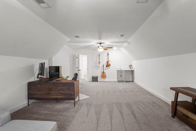 bedroom featuring light carpet, baseboards, visible vents, and vaulted ceiling