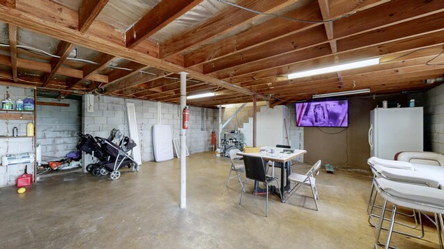 120 Gatone Dr, Hendersonville, TN 37075 - unfinished basement with stairway, freestanding refrigerator, and concrete block wall
